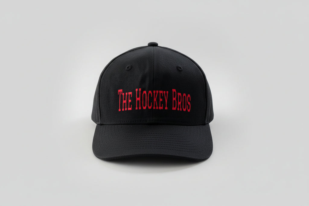 The Hockey Bros Cap in black with bold red vinyl text and holographic red flame detail — adjustable Velcro hockey cap by Sparkle & Slapshots
