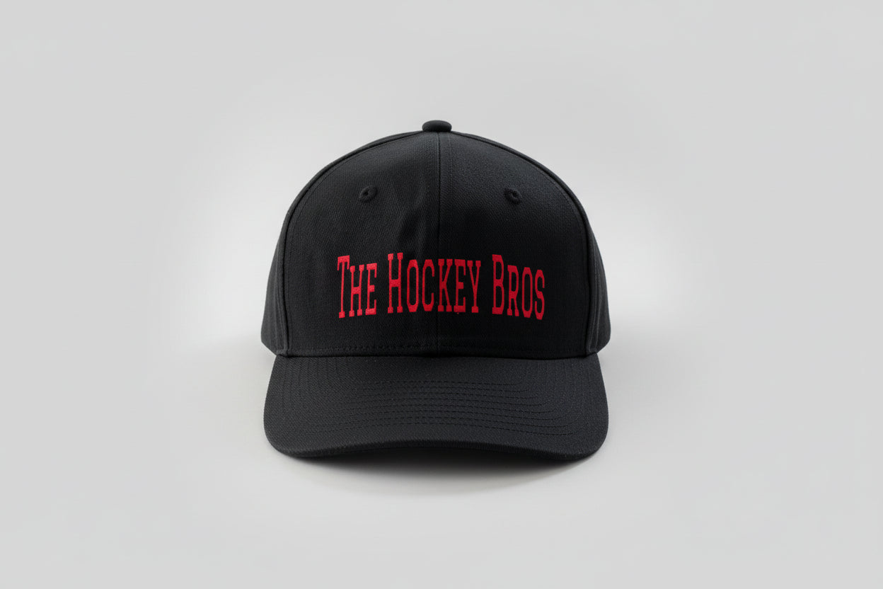 The Hockey Bros Cap in black with bold red vinyl text and holographic red flame detail — adjustable Velcro hockey cap by Sparkle & Slapshots

