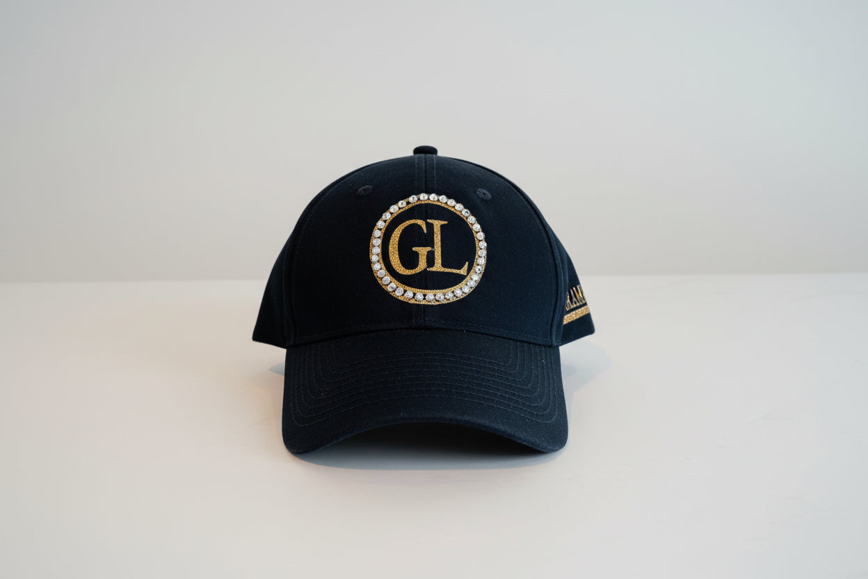 GL Cap Glam Luxe Hockey™ Cap featuring double gold glitter rings with rhinestone crystals, large GL monogram in glitter gold, and Glam Luxe with hockey stick detail — black cap
