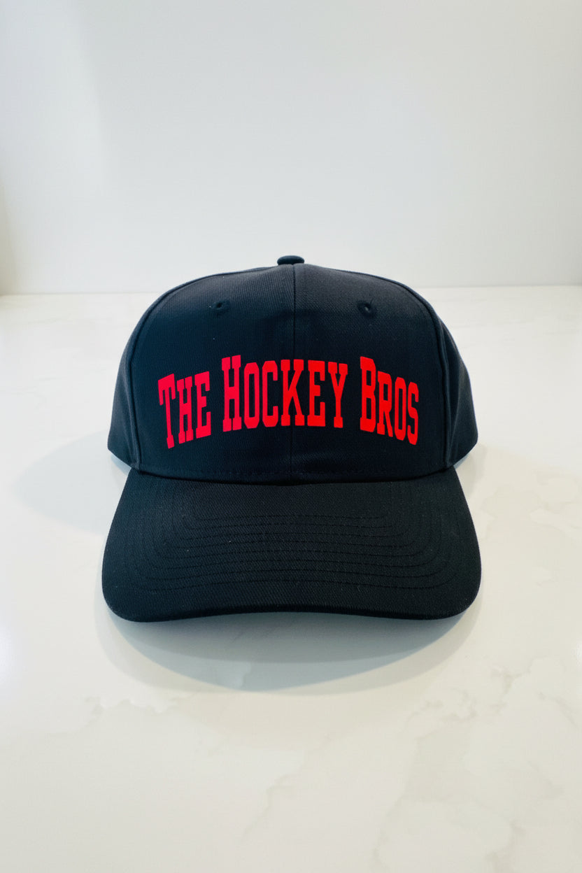 The Hockey Bros™ Classic Edition Cap. Boys hockey cap in black with bold red vinyl lettering, adjustable fit. Adult and kids sizes 