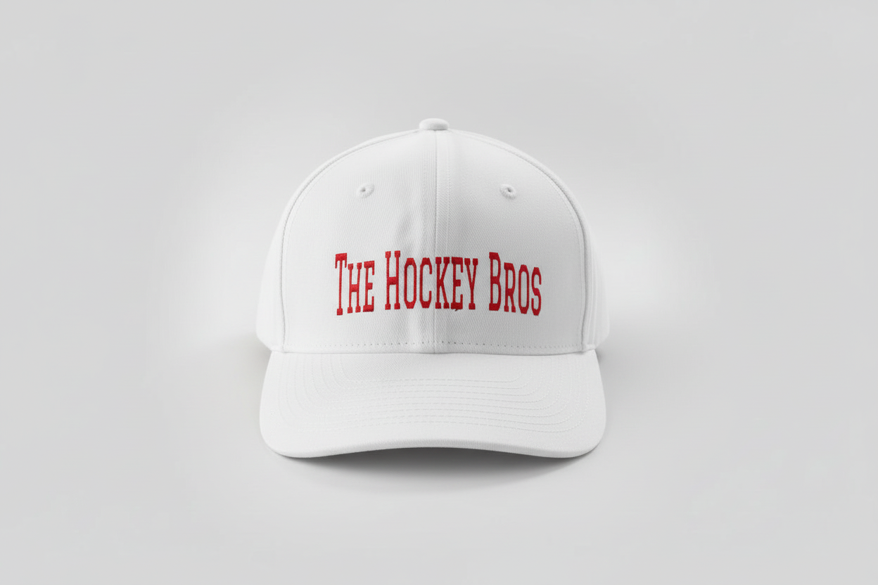 The Hockey Bros™ Cap in white — adjustable boys hockey hat with red vinyl branding and holographic flame detail, kids and adult sizes 